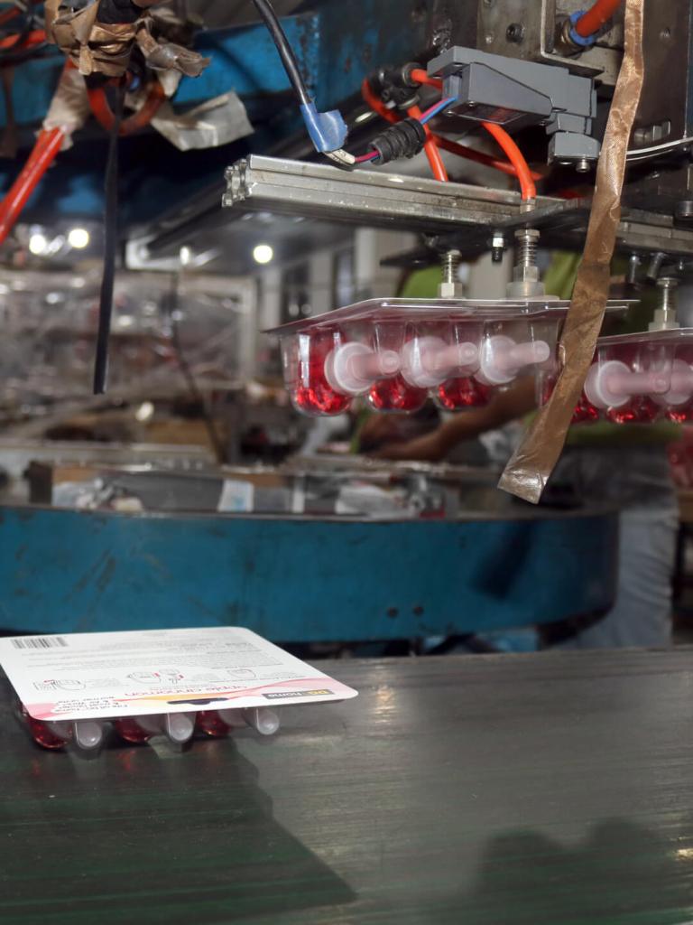 Bottles are machine-sealed into blister cards for retail sale