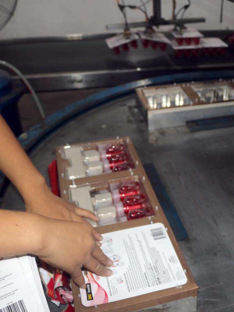 Bottles are machine-sealed into blister cards for retail sale